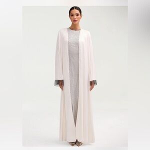 veiled collection open white abaya with black crystal mesh sleeves.